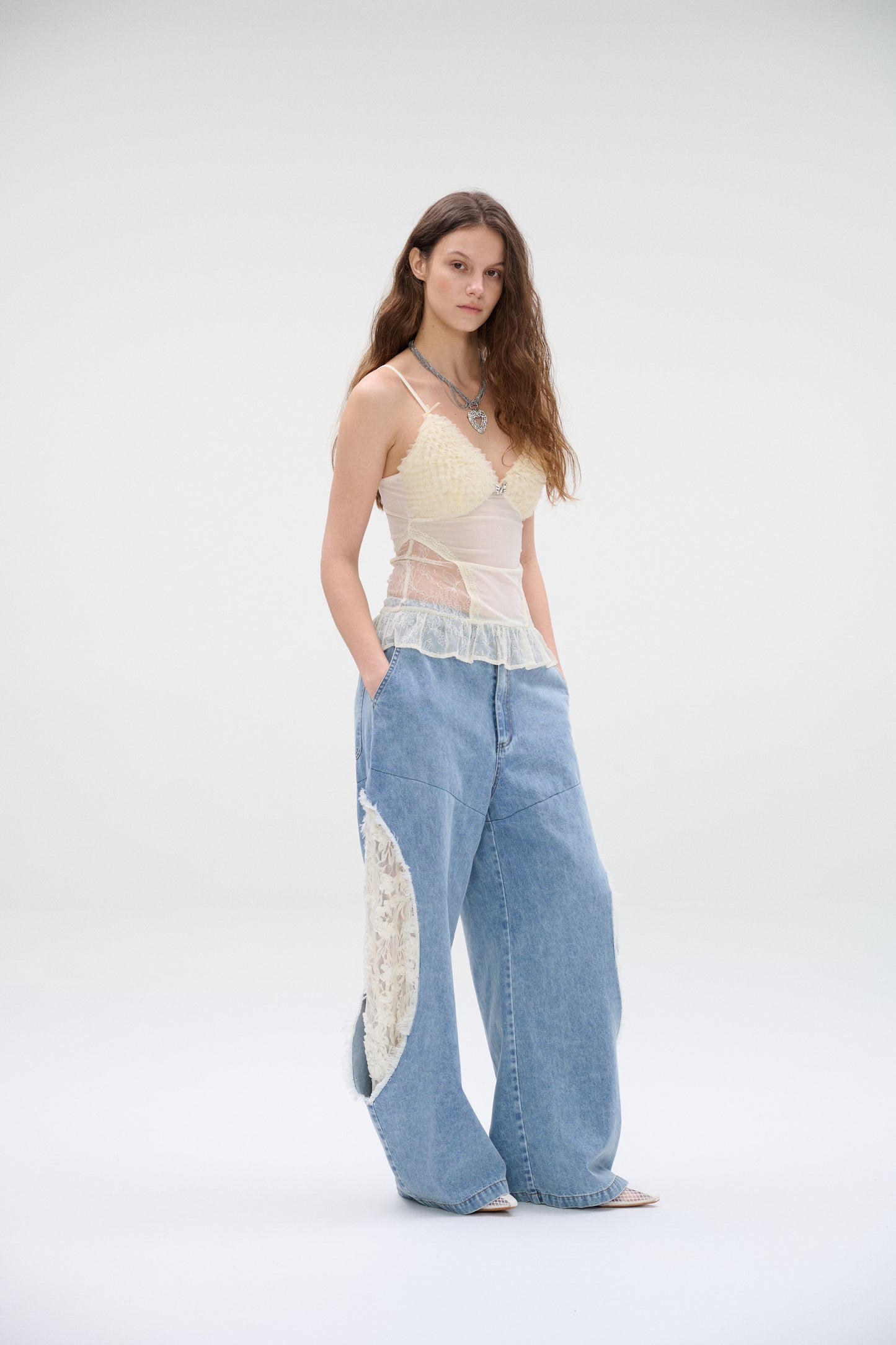 Wide-leg denim jeans with lace panel cutouts